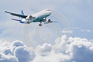 Passenger airliner flies above the clouds