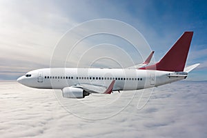 Passenger airliner flies in the air above the clouds