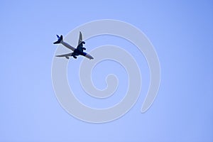 Passenger airplane against clear blue sky, traveler