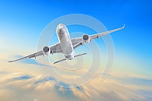 Passenger airplane is climbing high flight level in the sky above the clouds, motion speed blur.