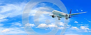 Passenger airplane flying above clouds. View from the window plane to amazing sky with beautiful clouds.