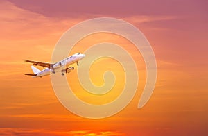 Passenger airplane flying take off on sunset
