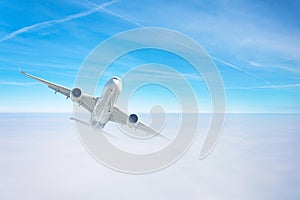 Passenger airplane gains altitude flying through a dense cloud layer
