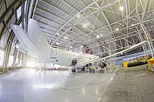 Passenger airplane on maintenance of engine, fuselage and on auxiliary power unit. check repair in airport hangar. Aircraft view t