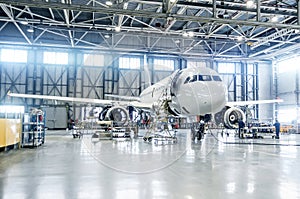 Passenger airplane on maintenance of engine and fuselage check repair in airport hangar. photo