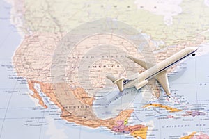 Passenger airplane miniature on a map taking off from USA