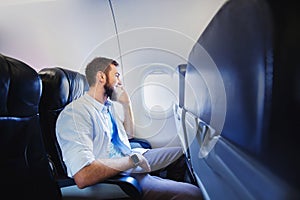 Passenger of airplane talking on mobile phone