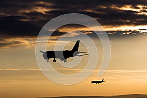 Passenger airplanes landing in the evening sun photo