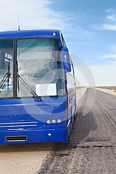 Passenger blue bus on the roadside