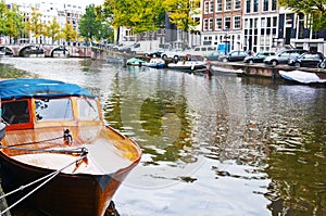 Passenger boat on the Herengracht canal in Amsterdam