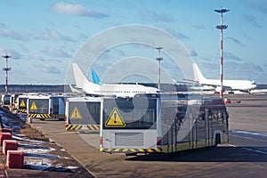 Passenger buses parked in a row parked at the airport