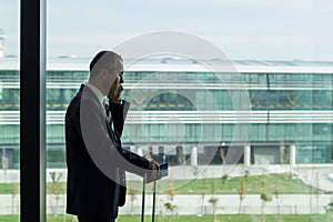 Passenger business man at the airport talking with phone