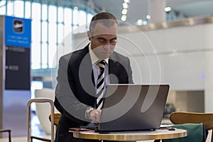 Passenger business man working with laptop at the airport