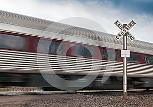 Passenger Car Flies by Railroad Crossing