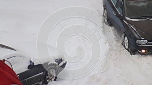 A passenger car got stuck in the snow. Wheels skid in snow on ice, close-up, wheelspin