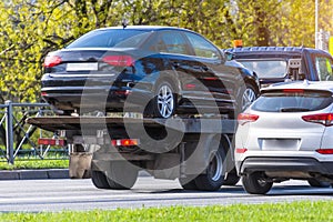 Passenger car loaded onto an evacuation truck rides along the road