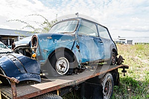 Passenger car loaded onto a tow truck for transportation