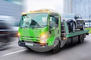 Passenger car loaded onto a tow truck for transportation, delivered to the destination. With motion blur speed effect