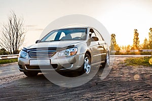 Passenger car sedan on the road in the sunlight, close-up