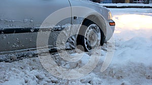 Passenger car stalled on snowy road.