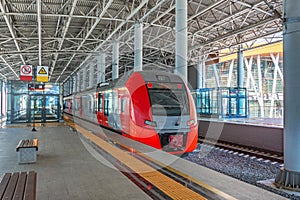 Passenger commuter train on station platform awaiting passengers