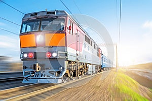 Passenger diesel train traveling speed railway wagons journey sunset light.