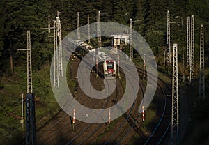 Passenger electric train coming to station Strba in Slovakia montains in morning