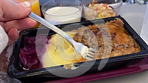 Passenger enjoys airplane food airplane food served by stewardess comfort in journey. Savouring airplane food traveler
