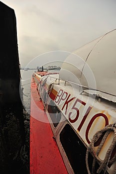 passenger ferry docked at pier people disembarking calm water hazy sky