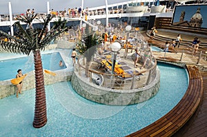 PASSENGER FERRY, MIDSEA, SPAIN - JUNE 09, 2012: Passengers enjoy at swimming pool on upper deck of The luxury cruise MSC SPLENDIDA