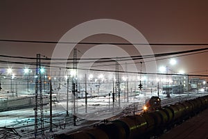 Passenger and freight trains on big railway station