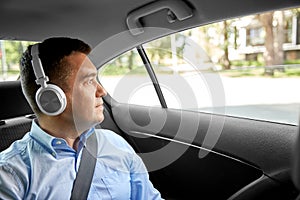 Passenger in headphones listening to music in car