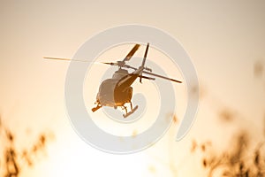 Passenger Helicopter flying in sunset sky