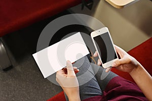 A passenger hold a train ticket mock-up and smartphone