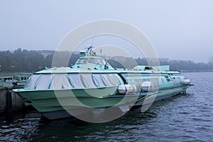 Passenger hydrofoil boat on the docks of Onego lake in foggy weather.