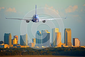 Passenger jet airliner plane arriving or departing Tampa International Airport in Florida at sunset or sunrise photo