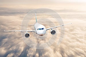 Passenger jet plane flies over overcast clouds