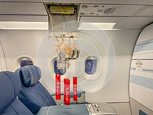 Passenger Oxygen Masks dropped from the ceiling above the seats to supply passengers with oxygen