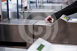 A passenger passes through an automatic ticket checking machine at a metro station