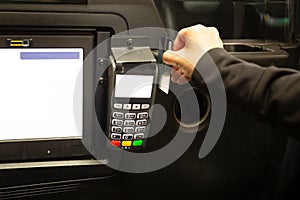 Passenger paying taxi fare with credit card