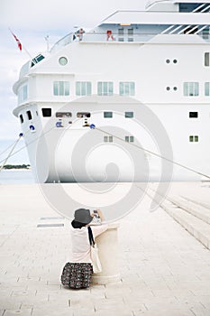 Passenger photographing big cruise ship