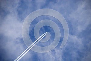 Passenger plane against white clouds.