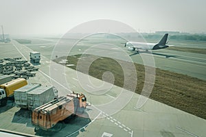 A passenger plane being serviced by ground services before next takeoff.