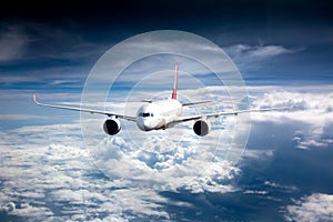 Passenger plane flies high above the clouds