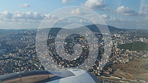 A passenger plane flies over Istanbul, the capital of Turkiye. Houses, streets, roads of Istanbul. Aircraft engine