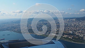 A passenger plane flies over Istanbul, the capital of Turkiye. Houses, streets, roads of Istanbul. Aircraft engine