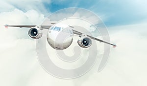 Passenger plane flying in blue cloudy sky.