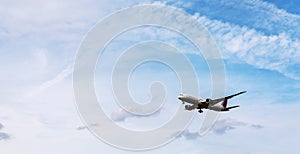 Passenger plane flying in the blue sky with clouds, cruise aircraft, transport industry