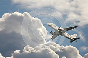 A passenger plane flying in the cloudy sky