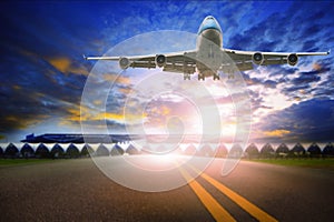 Passenger plane flying over airport runway ,traveling theme